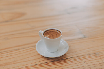 Closeup of coffee cup on table in empty corporate conference room before business meeting in office