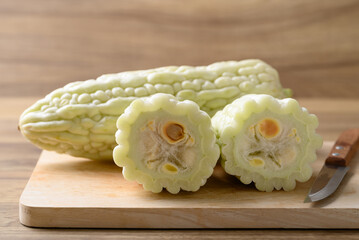 White bitter gourd on cutting wooden board, Asian food ingredient and herbal medicine