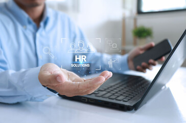 HR solution concept Businessman holds human resource solution icon on virtual screen with technology in human resource management.