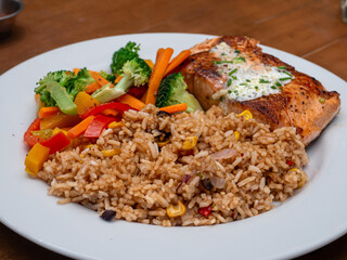 Salmon steak with fried rice in the restaurant at Metro Manila, Philippines
