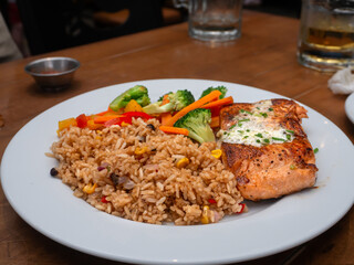 Salmon steak with fried rice in the restaurant at Metro Manila, Philippines
