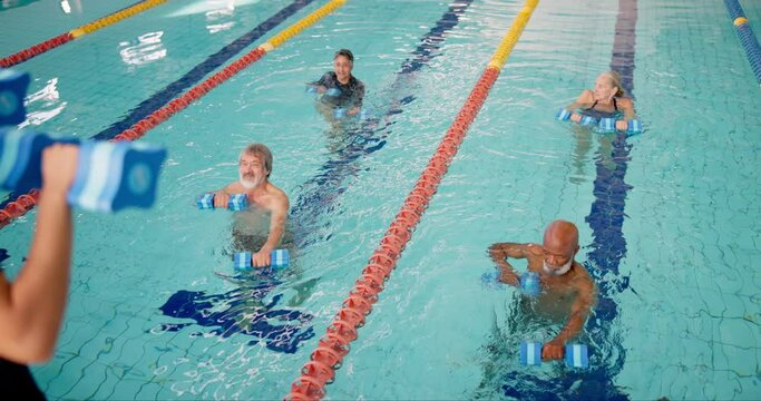 Dumbbell, fitness or people in swimming pool with instructor for exercise, healthy body or strong muscle. Weight, senior group or aerobics class in water for training, physiotherapy or rehabilitation