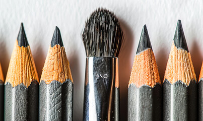 Unique Brush Contrasted Among Sharpened Graphite Pencils in Creative Arrangement Concept of Individuality and Creativity