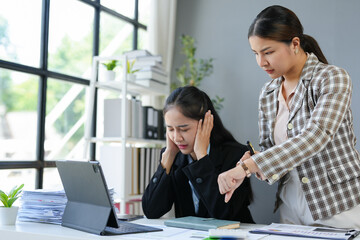 Asian businesswoman, tired office worker Stressed by being scolded for delayed working hours. Work not completed as intended by supervisors, executives, office syndrome concept.