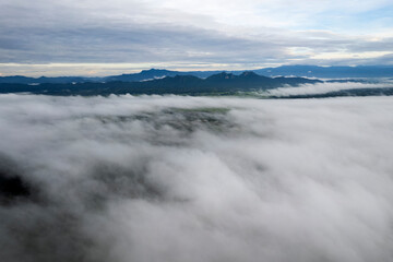 Landscape of Morning Mist with Mountain Layer at north of Thailand. mountain ridge and clouds in rural jungle bush forest