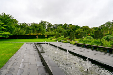 Sofiero Palace Gardens, green park with paths and large trees in Sofiero Castle, Sofiero Slott och Slottsträdgard as a tourist attraction in Helsingborg, Sweden	
