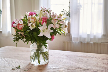 Flowers, home and blossom spray for decoration, sustainable bouquet and house plants. Indoor, posy and collection for interior design or botanical growth in apartment, leaves and blooming on table