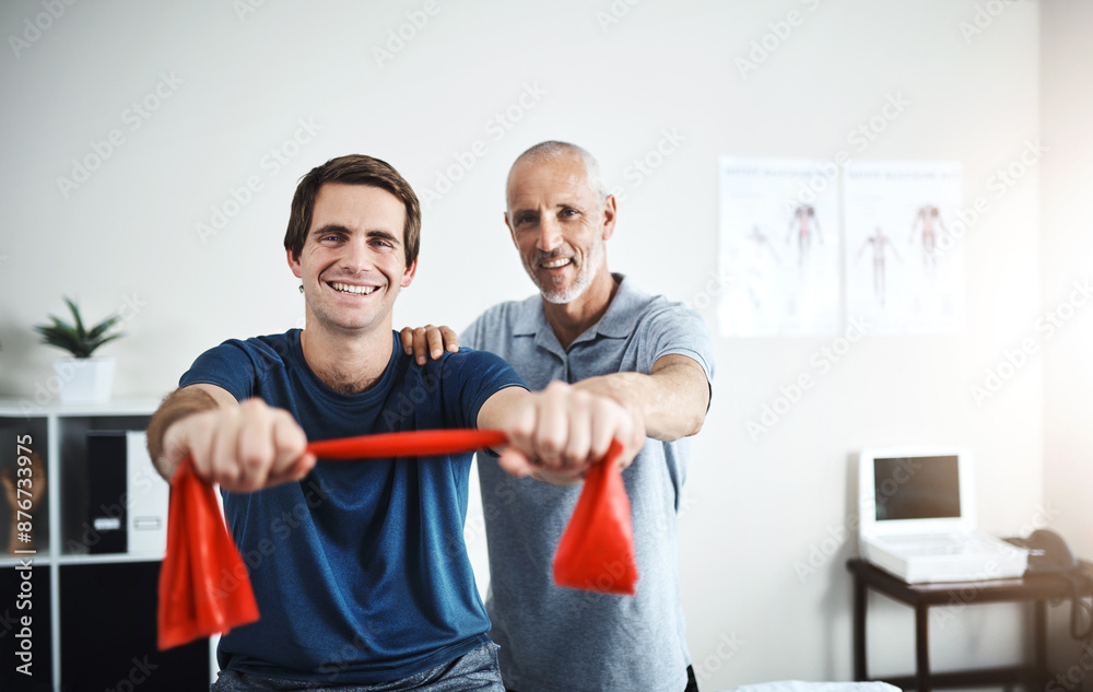 Poster Portrait, resistance band training and man with physiotherapist in office for appointment or checkup. Exercise, fitness and smile of medicine professional with physiotherapy patient in rehab clinic