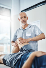 Men, knee pain and physiotherapist consulting or working, rehabilitation with exercise for wellness. Male people, office and chiropractic for physiotherapy service with health insurance or stretch