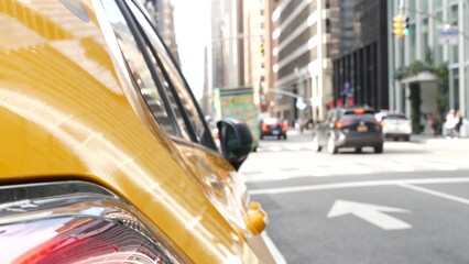 New York City. Yellow taxi car on Manhattan street. Taxi cab on Midtown Lexington avenue. Medallion taxicab rear view on Lex ave waiting for people or passengers on road. Urban scene in United States.