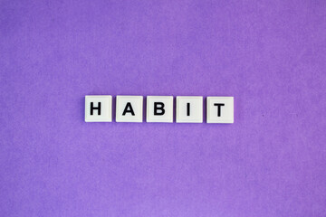 letters of the alphabet with the word habit. regular tendency or practice, especially one that is hard to give up.