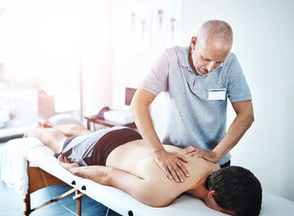 Physical therapist, men and patient with back massage, injury and consultation for recovery,...