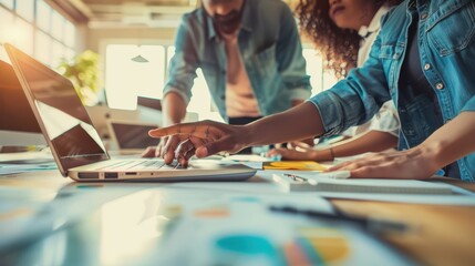 A detailed close-up of colleagues brainstorming together, intense discussion, diverse group, hands pointing at a laptop