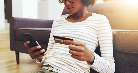 Black woman, relax and home with credit card or smartphone for digital purchase. Girl, floor and mobile banking for subscription and virtual store payment, online shopping and secure transaction.