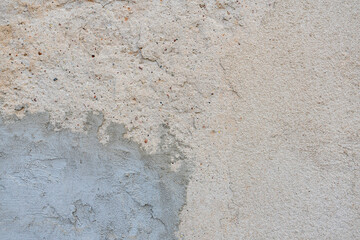 old plastered wall repaired with concrete
