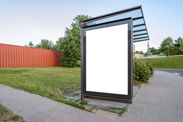 Bus Stop Advertising Poster Mockup On A Street Sidewalk. White Blank Outdoor Billboard For Commercial Campaign