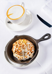 meringue cake with cappuccino on the table