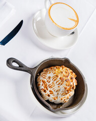 meringue cake with cappuccino on the table