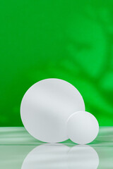 Decorative podiums on green background in studio
