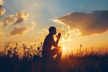 Christian prayer. Man on his knees praying on sunset background. Kneeling prayer to God. Worship and praise