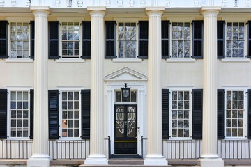 Obraz premium Colonial building facade with symmetrical design, white columns, and shuttered windows, Generative AI