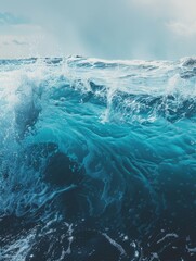A big blue wave crashes into the ocean waters, providing a stunning visual effect