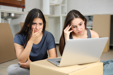 Worried roommates reforming house checking laptop