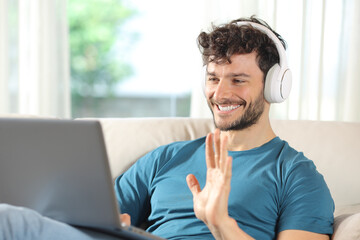 Happy man having video call on laptop at home
