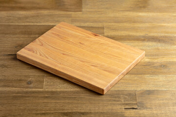 Cutting board on a wooden table.