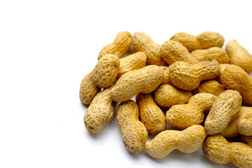 Roasted peanuts in shell on white background.