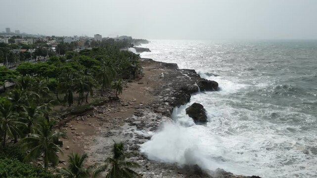 Aerial drone view of Santo Domingo rocky coastline relentlessly assaulted by crashing waves, Dominican Republic