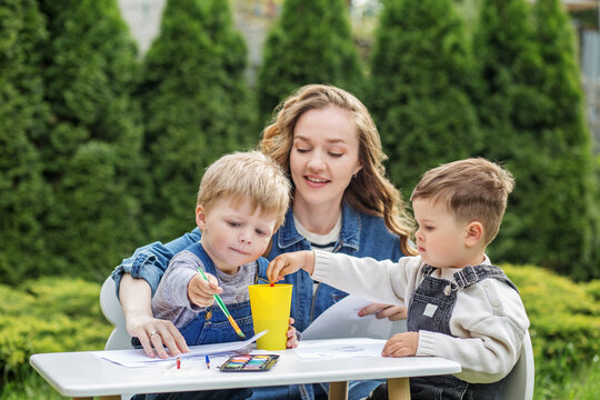 Mother and Sons Enjoying Outdoor Painting