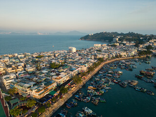 Fototapeta premium Cheung Chau, Hong Kong: Aerial drone view of the Cheung Chau island, famous for its fisherman harbor and relaxing traditional town in Hongkong.