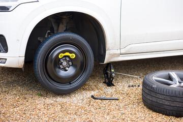Changing a tyre (tire) on a car, changing a wheel with car on a jack