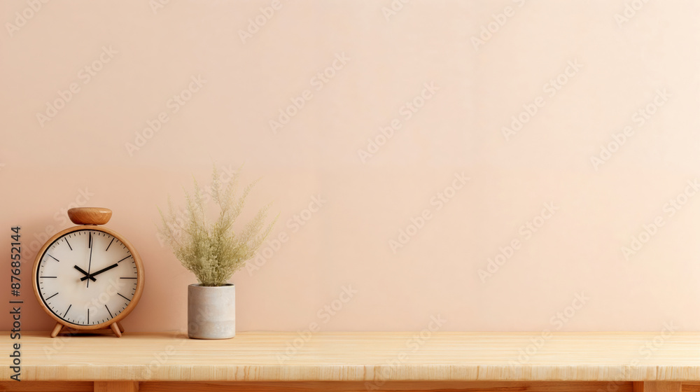 Poster minimalist home office desk setup featuring a clock and a plant is set against a calming empty pink 