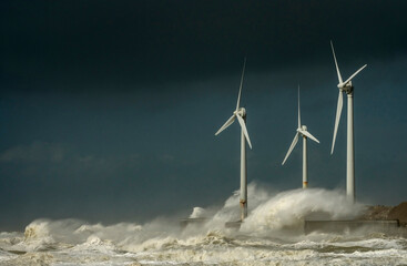 Storm waves smashing over wind turbines
