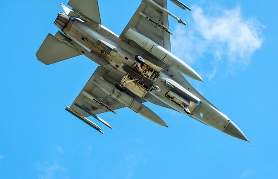 F-16 fighter plane flying under blue sky