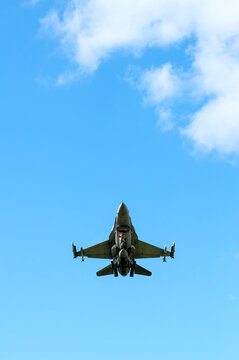 F-16 fighter bomber plane flying under blue sky