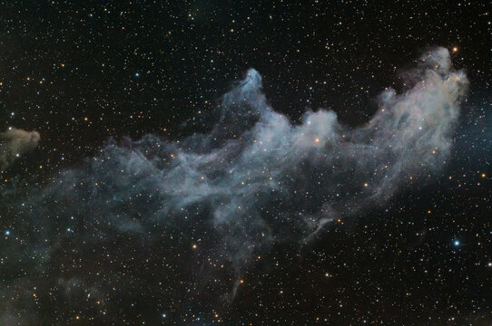 Long exposure astrophoto with telescope featuring faint reflection of Witch Head Nebula