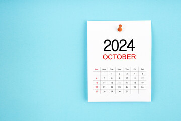 October 2024 calendar page with push pin on blue background.
