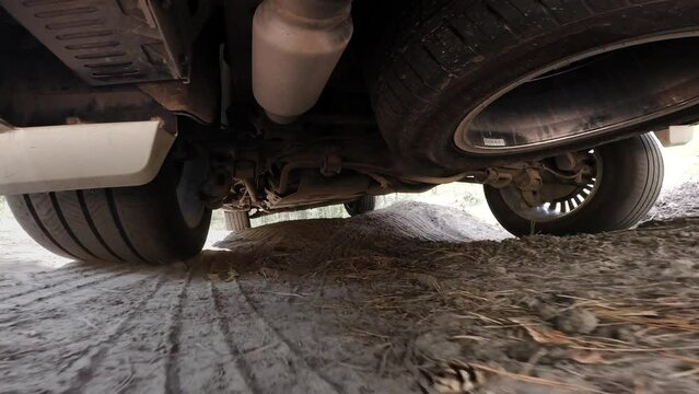 The operation of the car suspension in motion. Camera on the bottom of the car