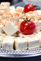 White cheese with cherry tomatoes on plate