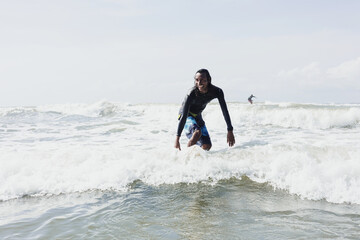 portrait of latin surfer man rides the tropical waves in Mexico Latin America, hispanic people surfing in summer sport activity