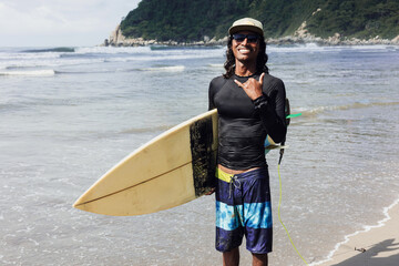 portrait of latin surfer man rides the tropical waves in Mexico Latin America, hispanic people...