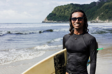 portrait of latin surfer man rides the tropical waves in Mexico Latin America, hispanic people...
