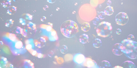 Soap bubbles with rainbow reflections on gray background. Abstract background. Cleaning concept,...