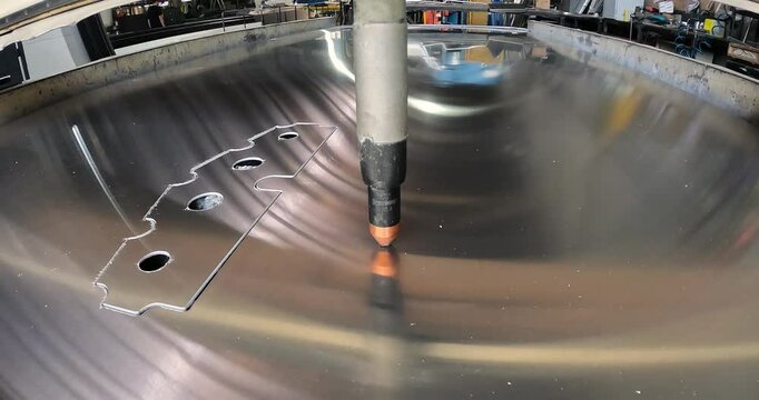 The plasma cutter will cut the part. The process of cutting a metal part with a plasma cutter. Plasma cutting Plasma cutter work at the factory.