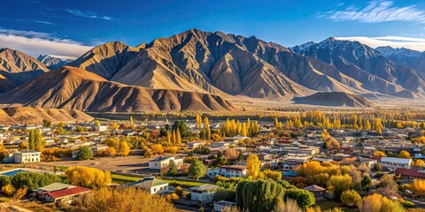 Small Kyrgyz town Balykchy cityscape with massive mountain ridge in sunny autumn afternoon, Balykchy, Kyrgyzstan, cityscape