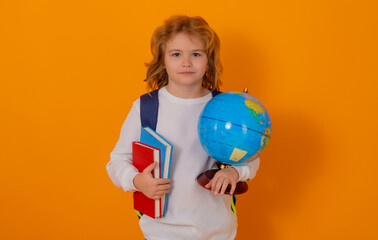 School boy world globe and book. School kid 7-8 years old with book go back to school. Little student in school. Education concept.