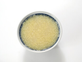 A bowl of nutritious breakfast millet porridge on the white table